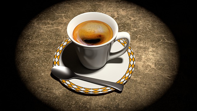 A cup of coffee with saucer and spoon